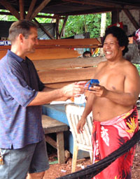 Nob Kalau hands over a fix-tuned, solar-powered radio to Hagar Charlie on Pohnpei